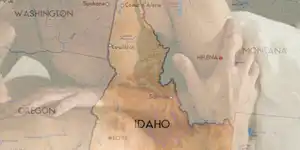 Map of Idaho overlaid with a couple in their underwear in a bed