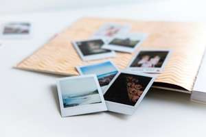 Polaroid photographs spilling from an album