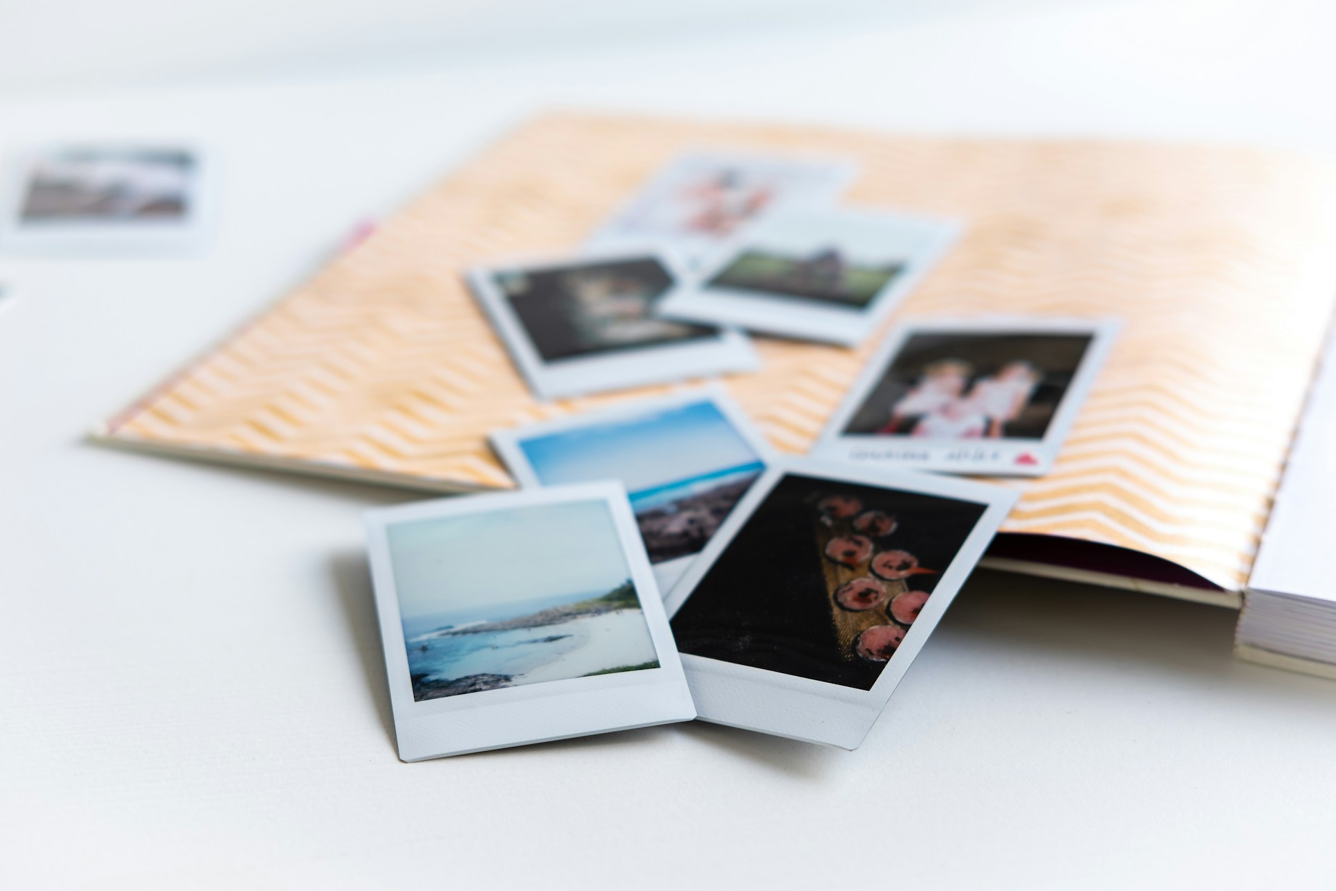 Polaroid photographs spilling from an album