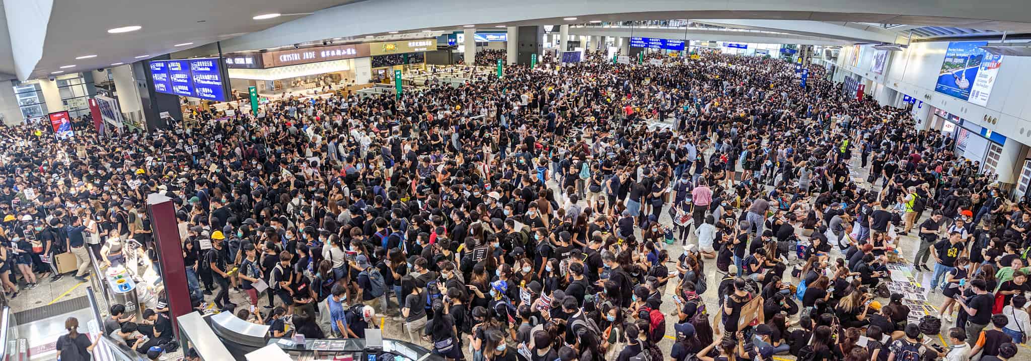 A dense crowd of thousands of people at an airport