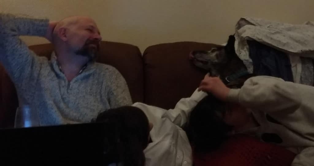 Photograph of an astonishingly handsome man, two children and a dog