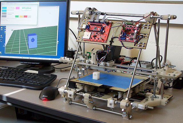 RepRap Mendel next to a PC