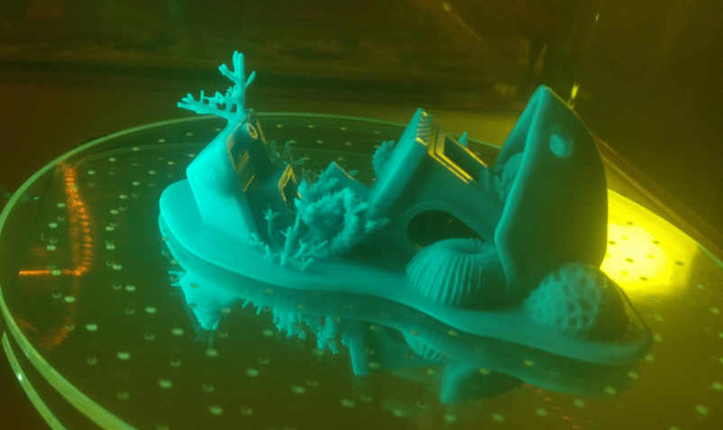 Sunken Benchy being cured in a yellow tinted container