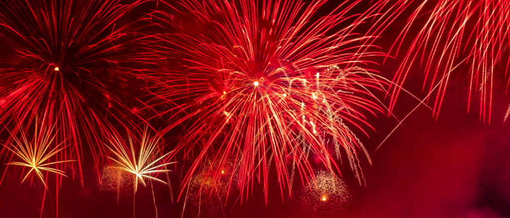 Red fireworks against a night sky