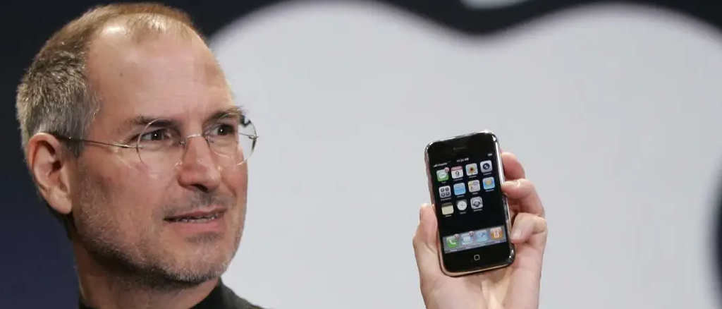 Steve Jobs holding an iPhone
