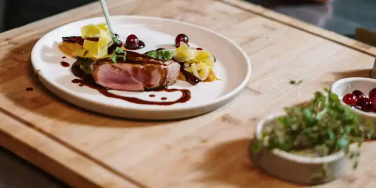 A delicately prepared dish on a wooden chopping board