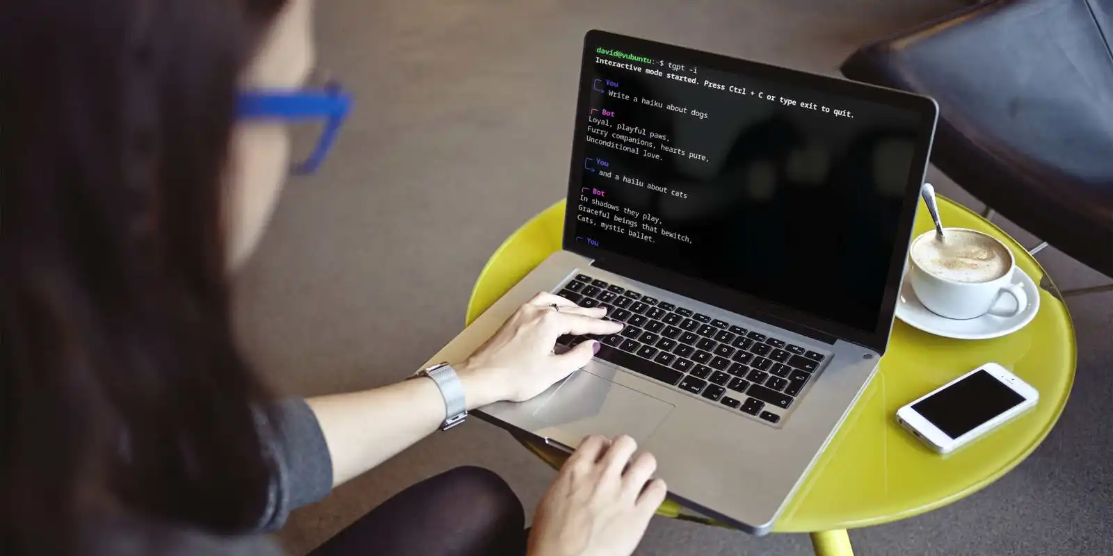 A woman with glasses using the terminal on a laptop