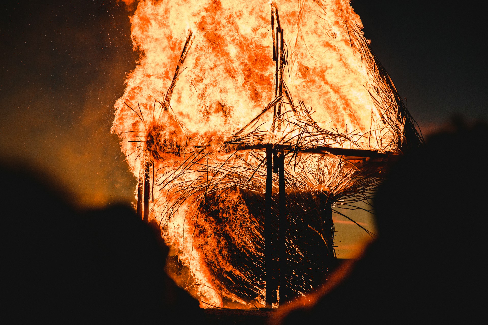 Boat frame on fire in the dark
