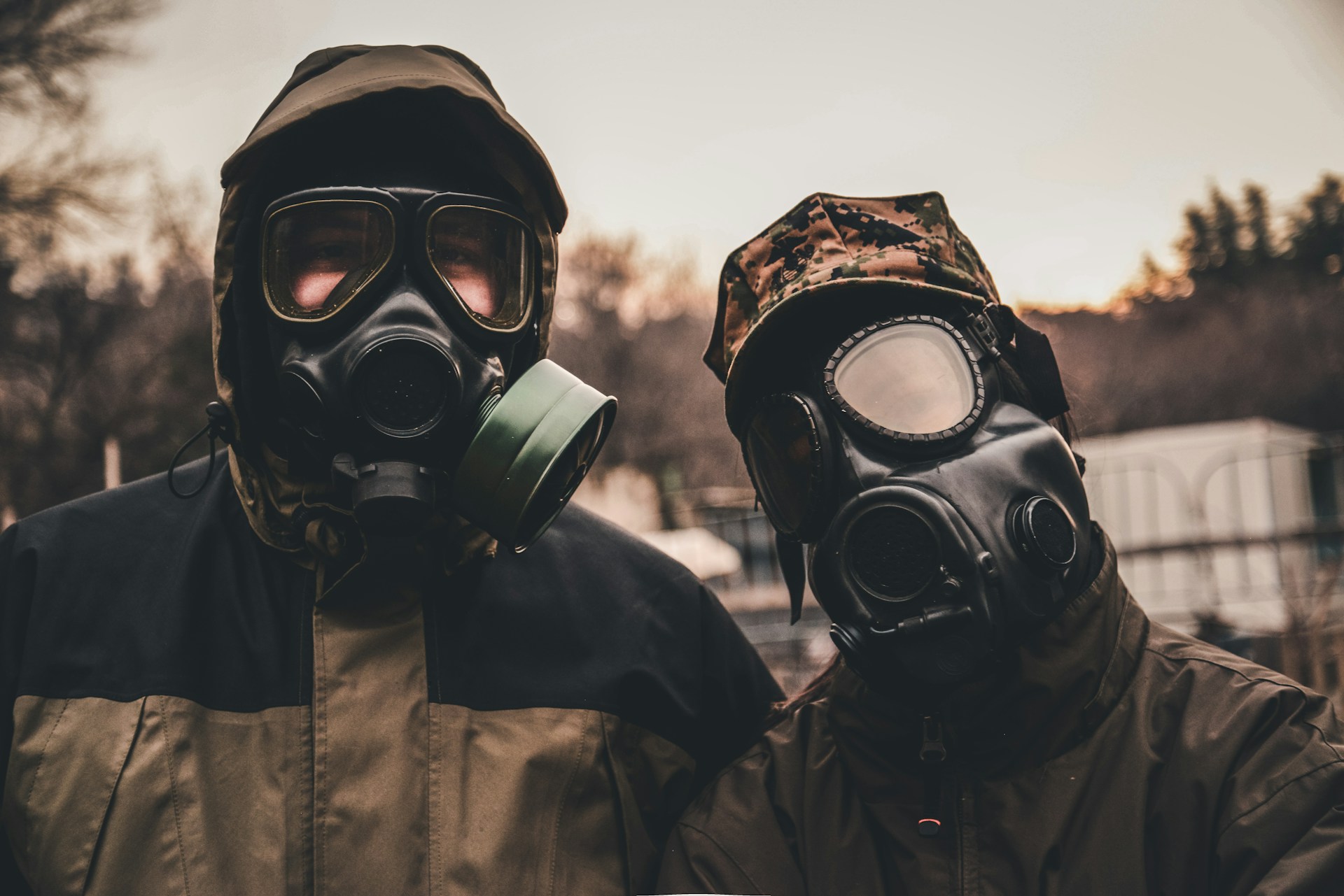 Two people wearing gas masks