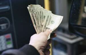 Hand extended holding money
