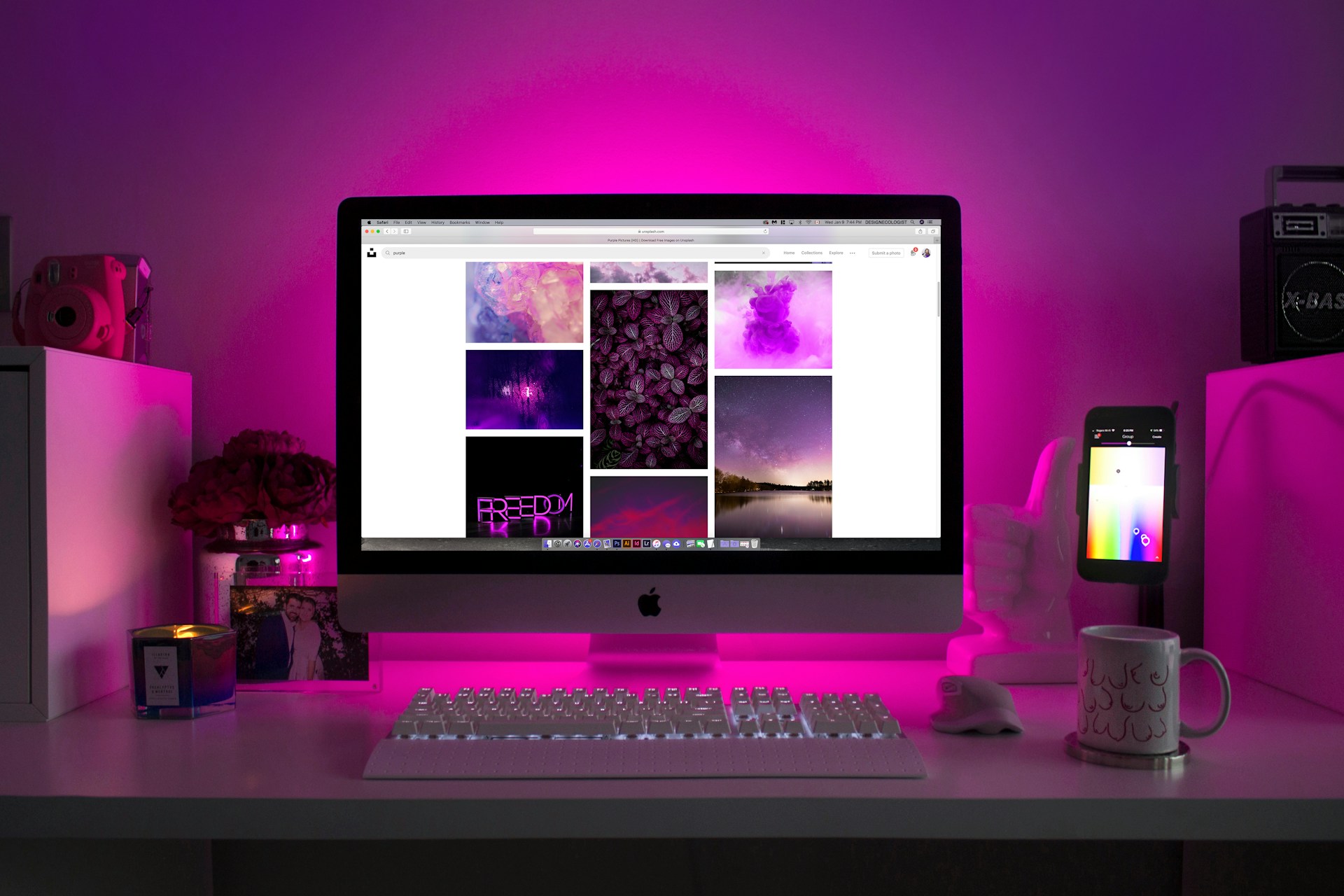 Apple mac on a pink lit desk