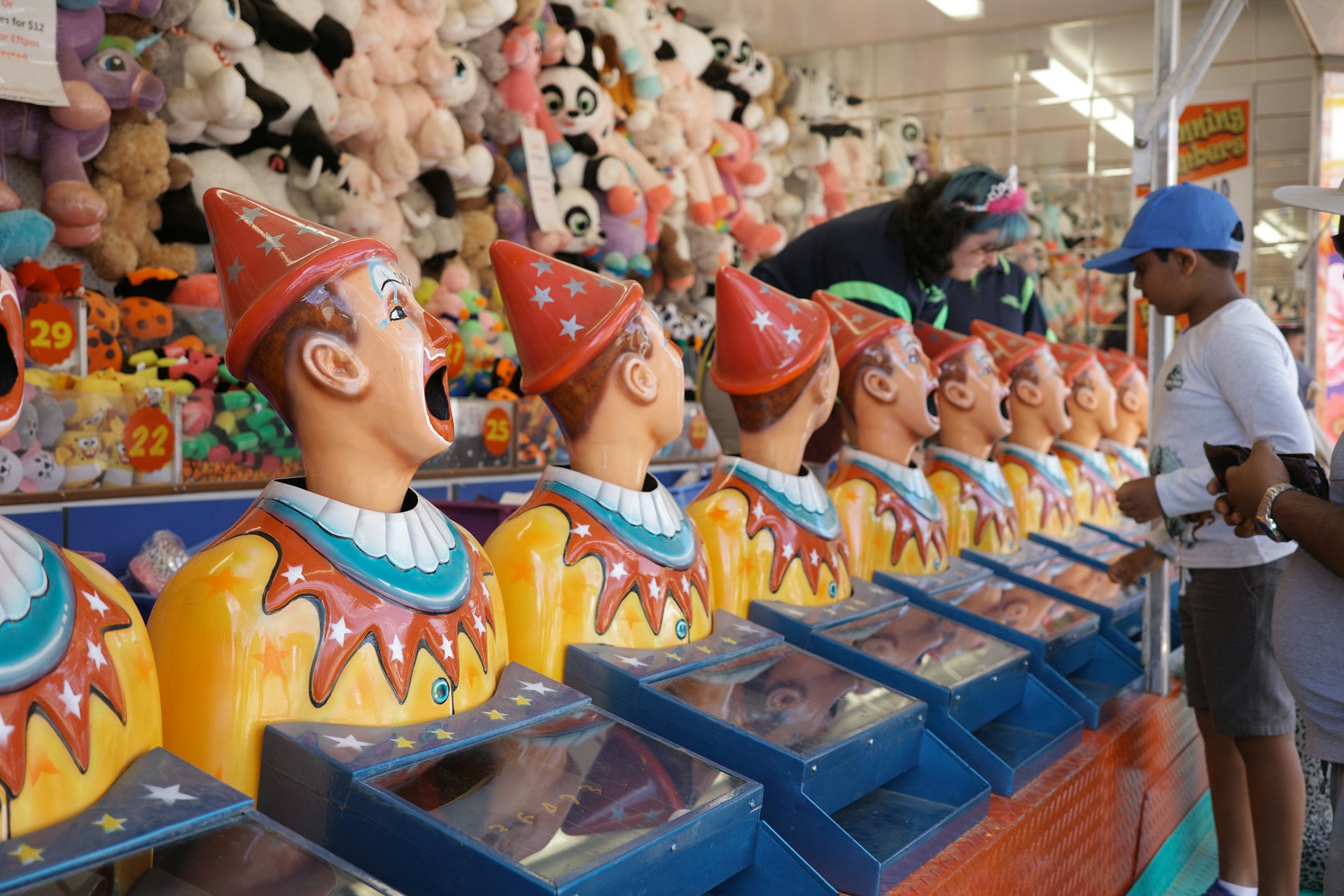 A row of plastic clowns at an arcade