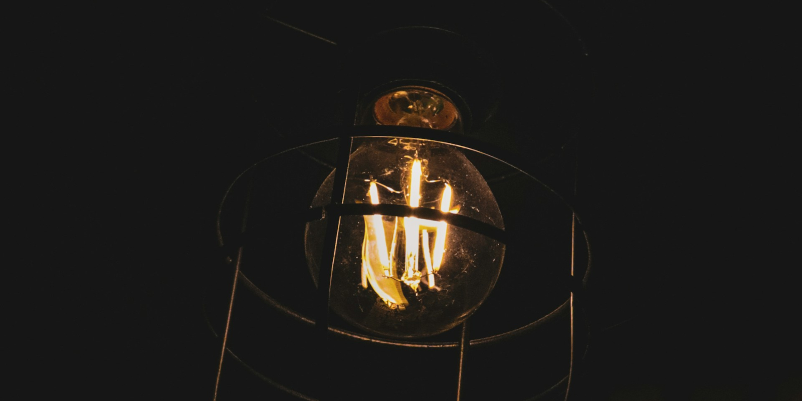 Incandescent lightbulb against a black background
