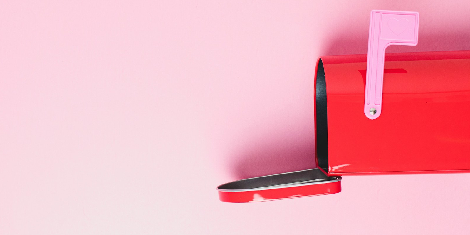 Red mailbox on a pink background