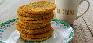 Cookies on a plate next to a "no drama" cup
