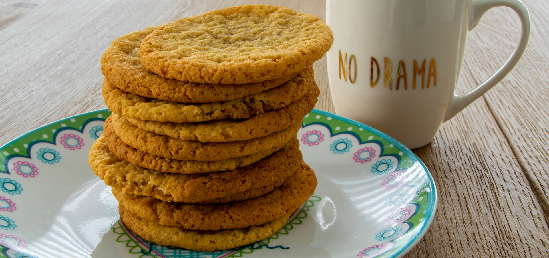 Cookies on a plate next to a "no drama" cup