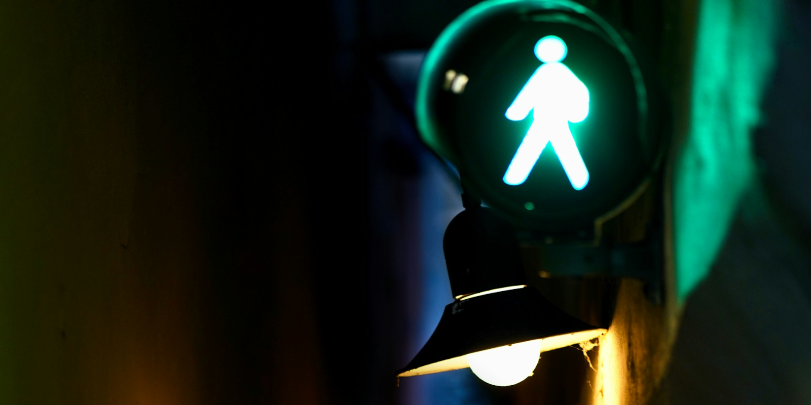 Illuminated pedestrian crossing sign at night