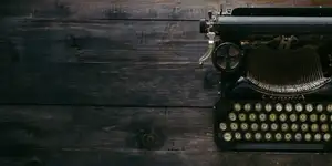 black typewriter on a wooden desk