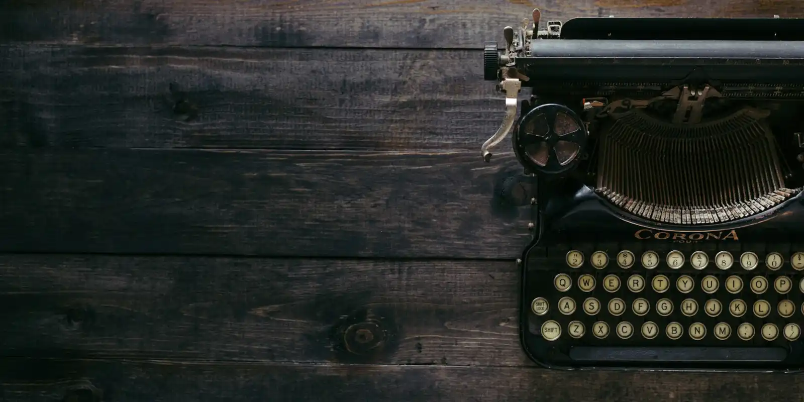 black typewriter on a wooden desk