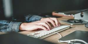 Hands typing on a keyboard