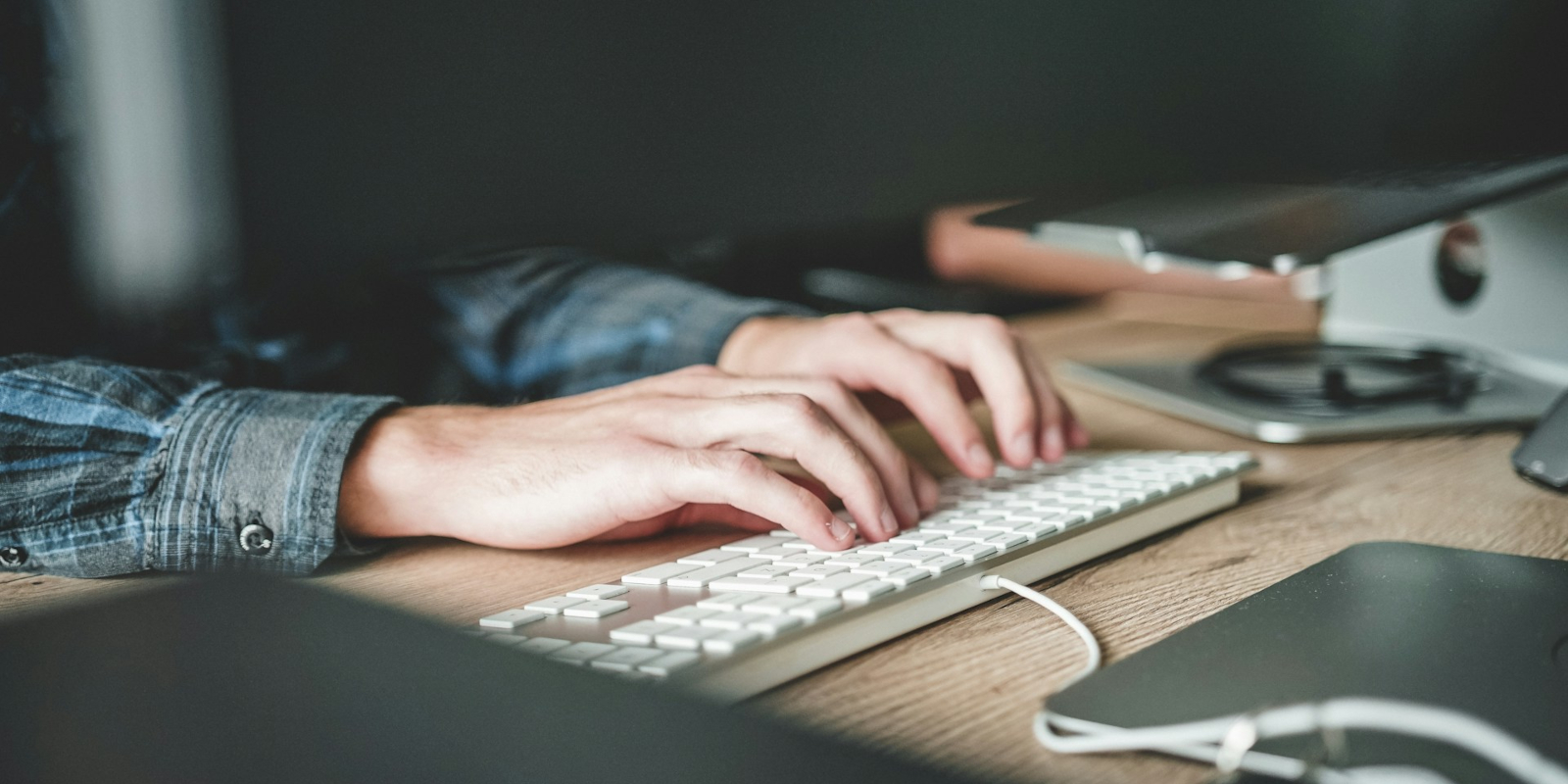 Hands typing on a keyboard