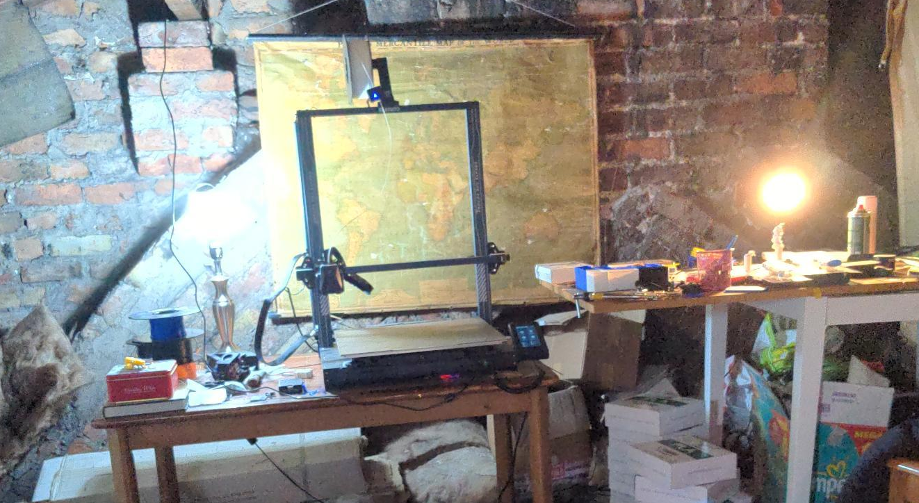 Large 3D printer on a table in a messy loft