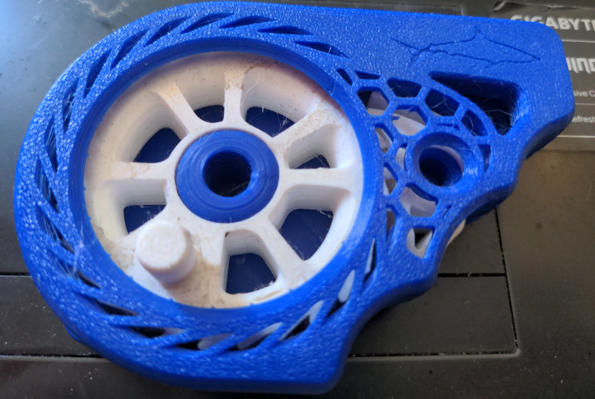 Blue and white Sharky fishing reel on a black background
