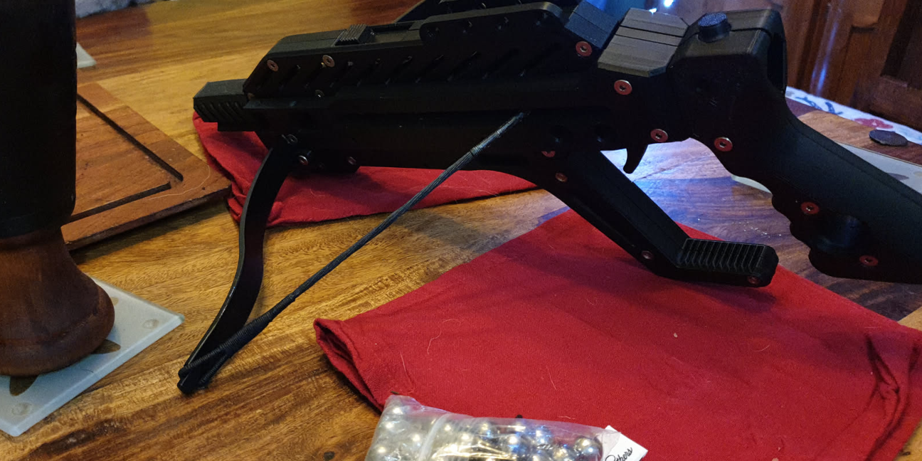 A cocked repeating crossbow on a table